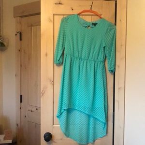 Teal/blue teen dress. Short in the front long in the back. Just was dry cleaned